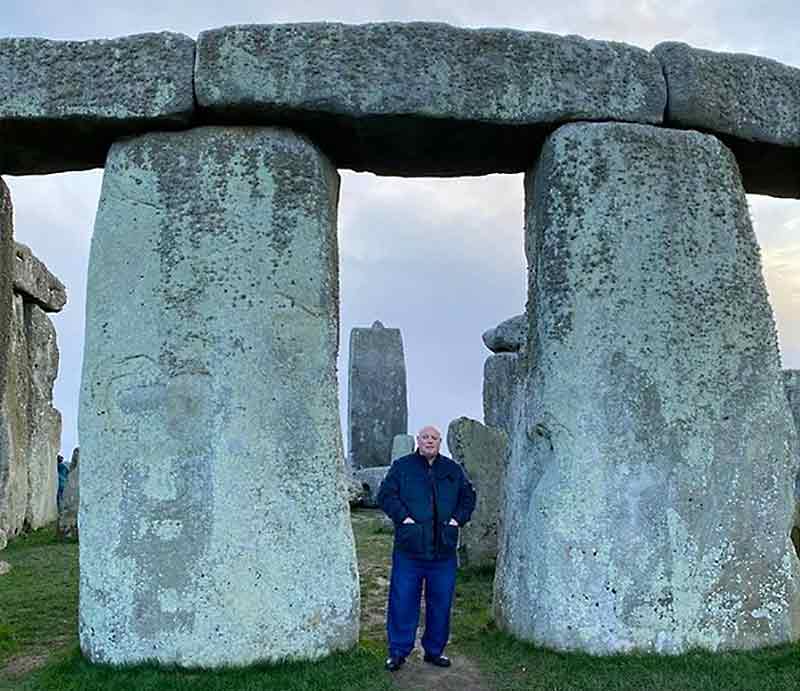 Tour guide Dave Stubbs between two giant sarsen stones.