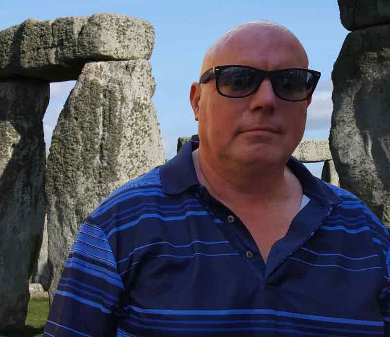 In front of the standing stones at Stonehenge.