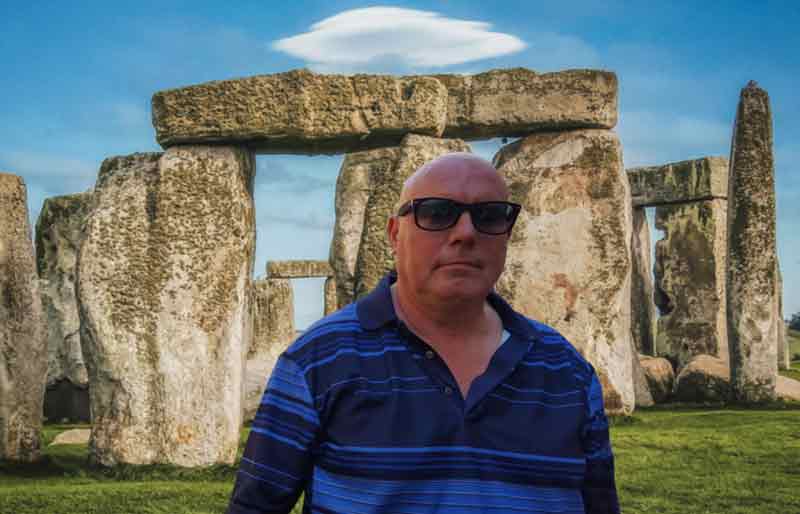 In front of Stonehenge on a bright sunny day..